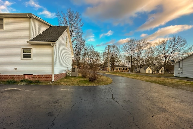 view of side of home with a lawn