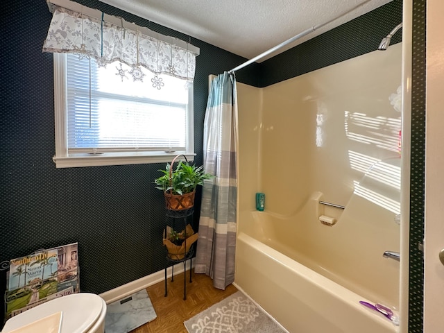 bathroom with toilet, shower / tub combo, parquet flooring, and a textured ceiling