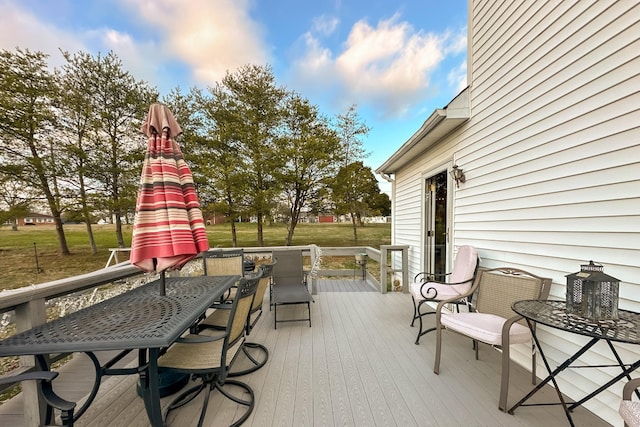 wooden terrace with a lawn