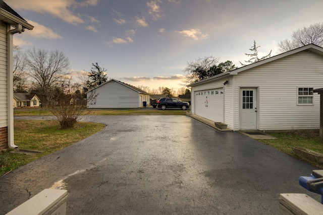 view of garage at dusk