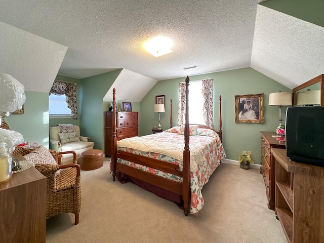 carpeted bedroom with a textured ceiling and vaulted ceiling