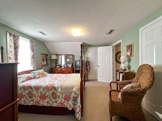 bedroom featuring a textured ceiling, carpet floors, and lofted ceiling