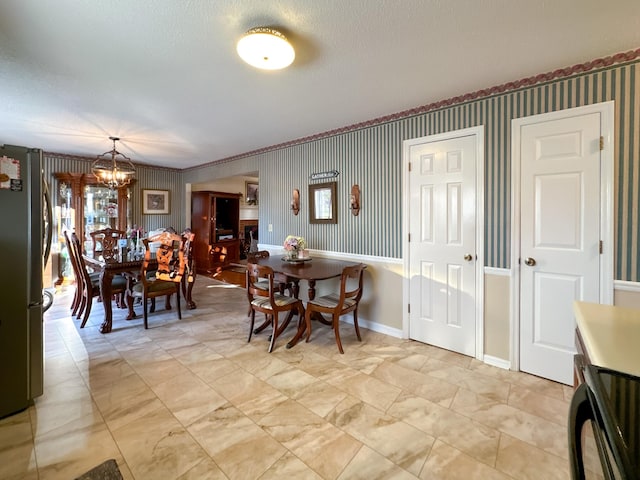 dining area featuring a textured ceiling and a chandelier