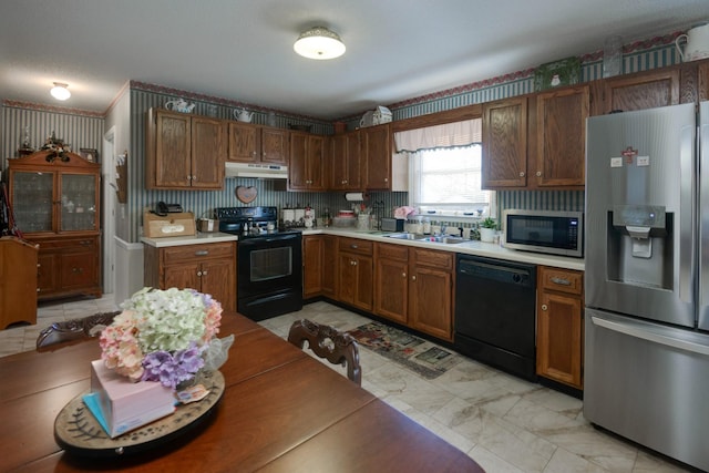 kitchen featuring black appliances, a textured ceiling, and sink