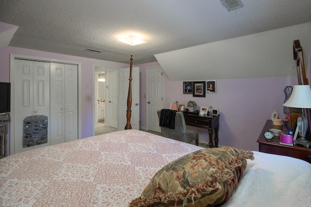 bedroom featuring a textured ceiling, a closet, and vaulted ceiling