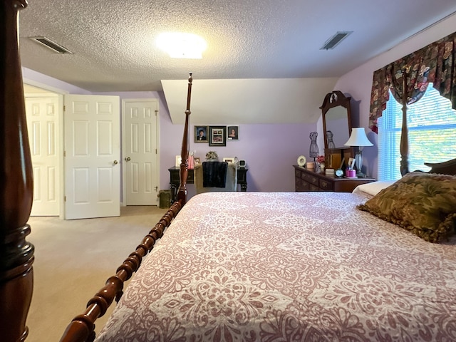 carpeted bedroom with a textured ceiling