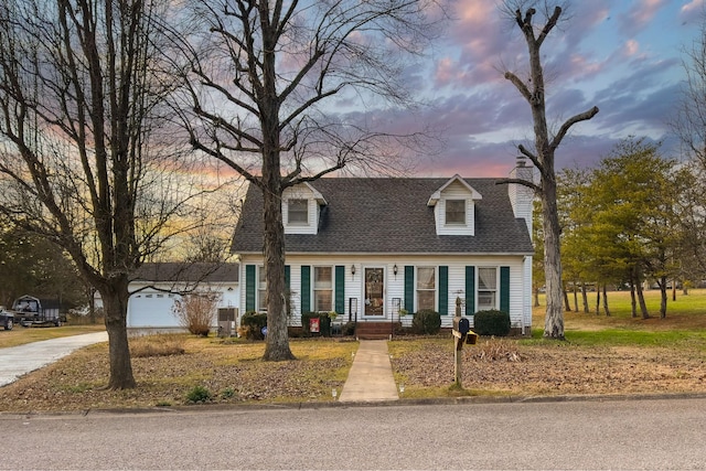 cape cod house with a garage and central AC