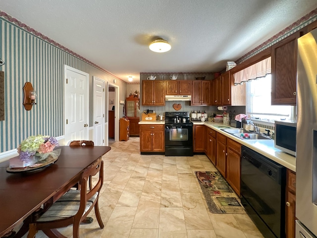 kitchen featuring sink, black appliances, and a textured ceiling