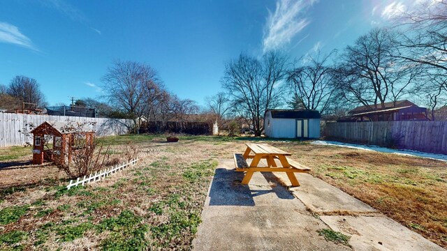 view of yard with a shed and a patio area