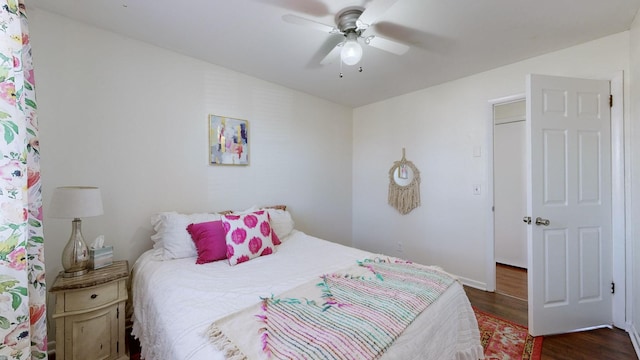 bedroom with ceiling fan and dark hardwood / wood-style floors