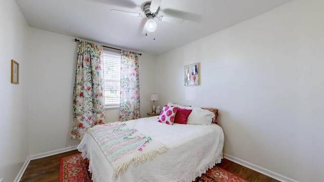 bedroom with ceiling fan and dark hardwood / wood-style floors