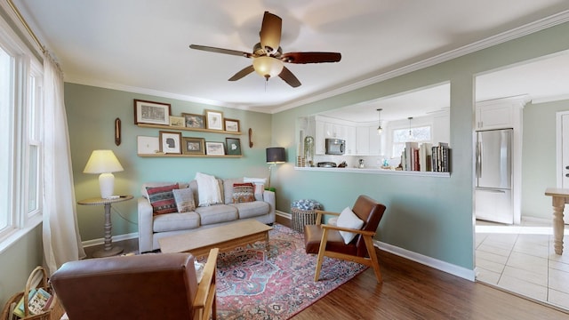 living room with ceiling fan, crown molding, and hardwood / wood-style floors