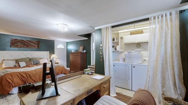 bedroom with separate washer and dryer and light hardwood / wood-style floors