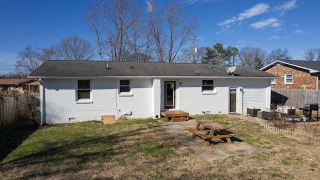 rear view of house with a patio area and a yard