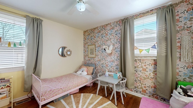 bedroom with ceiling fan and hardwood / wood-style flooring