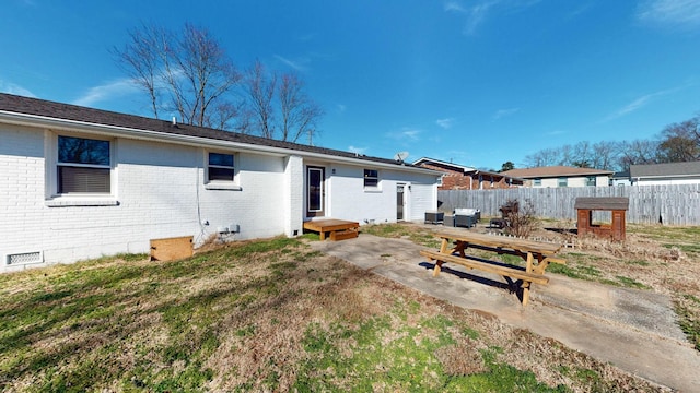 back of property with a patio