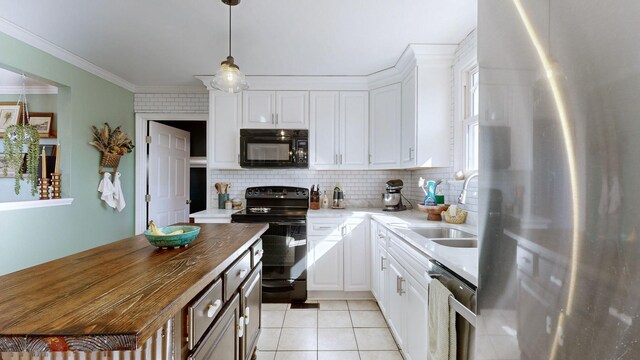 kitchen featuring light tile patterned floors, decorative backsplash, black appliances, white cabinets, and sink