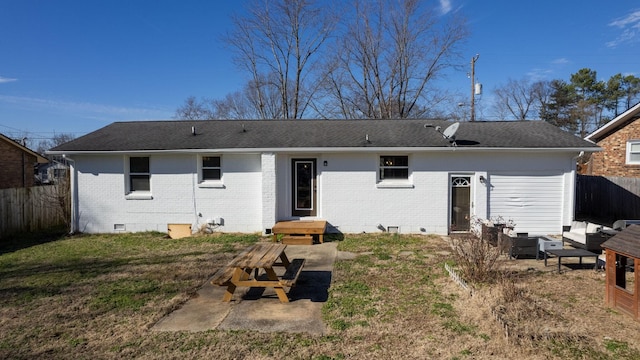 rear view of property with a lawn and a patio