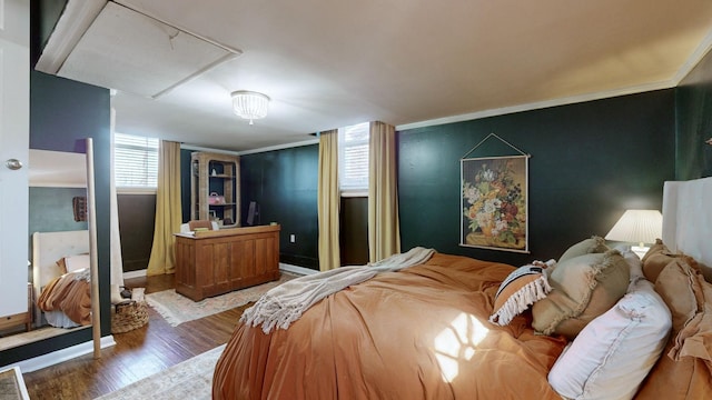 bedroom featuring crown molding and hardwood / wood-style flooring