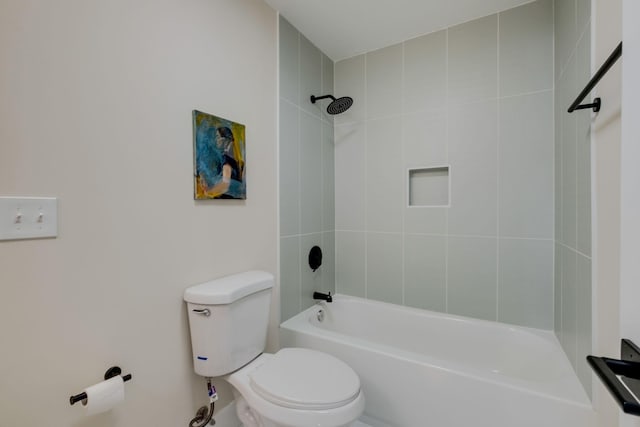 bathroom featuring toilet and tiled shower / bath combo