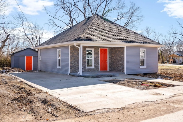 view of front of property featuring a garage and an outbuilding