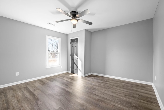 spare room featuring ceiling fan and dark hardwood / wood-style floors