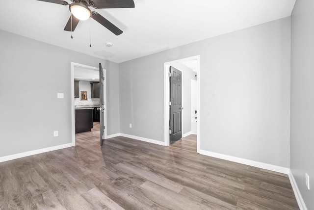 empty room with ceiling fan and wood-type flooring