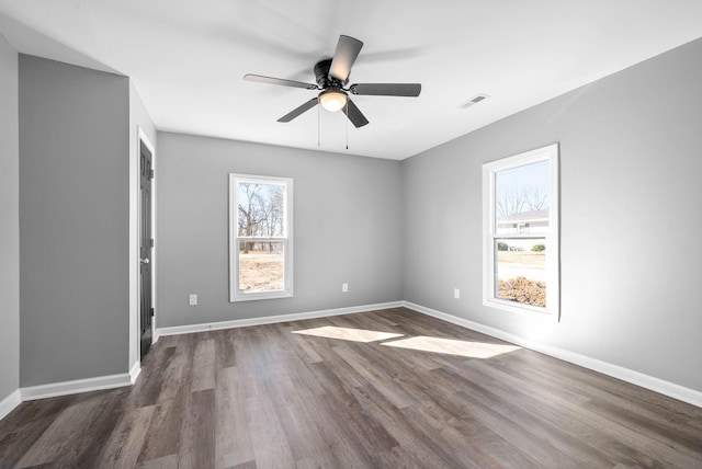 spare room featuring ceiling fan and dark wood-type flooring