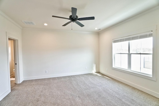 carpeted empty room with ceiling fan and crown molding