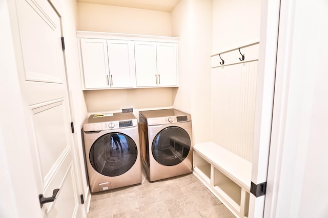 laundry room with cabinets and separate washer and dryer