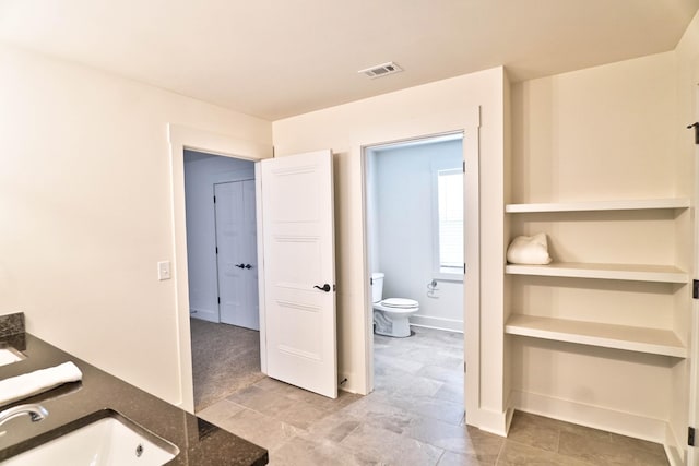 bathroom with toilet and vanity