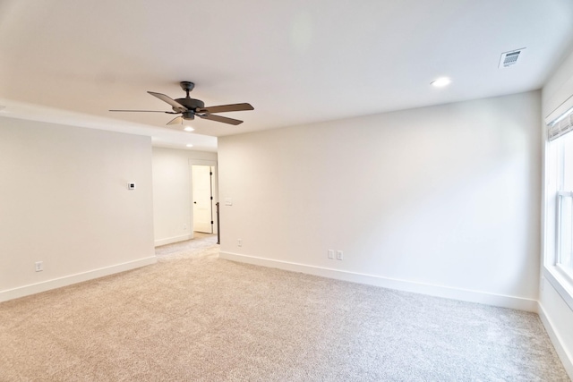 empty room with ceiling fan and light colored carpet