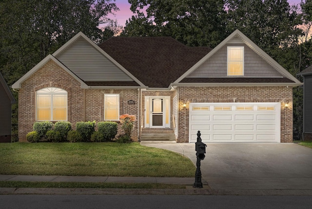 view of front of property with a garage and a yard