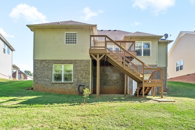 rear view of property featuring a wooden deck and a lawn