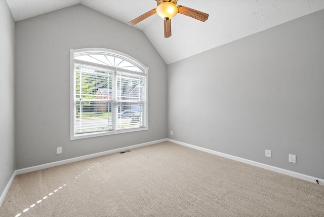 unfurnished room with ceiling fan, carpet, and lofted ceiling