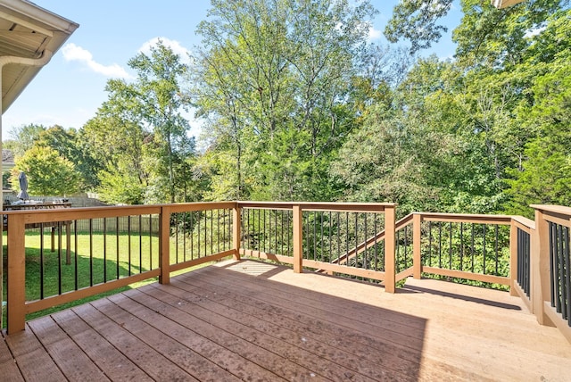 wooden deck featuring a yard