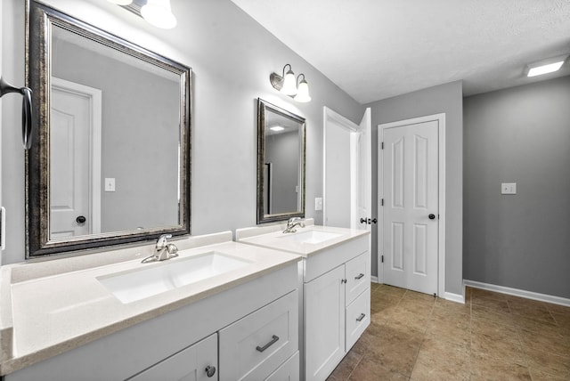 bathroom featuring a textured ceiling and vanity