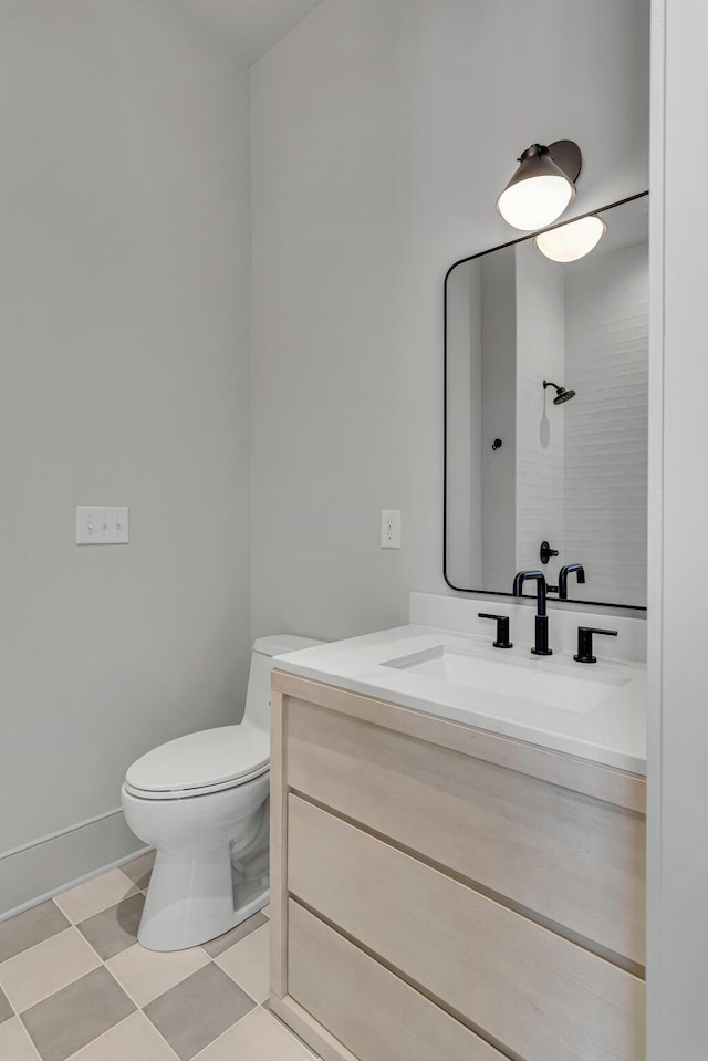 bathroom featuring toilet, tile patterned floors, and vanity