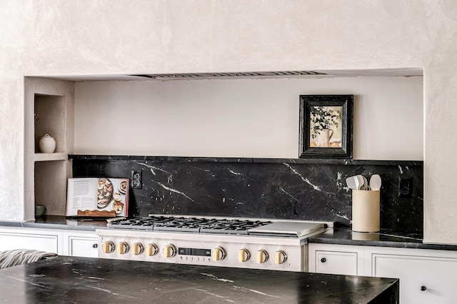 kitchen with gas cooktop, white cabinetry, and tasteful backsplash