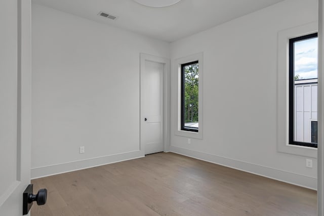 unfurnished room with light hardwood / wood-style floors