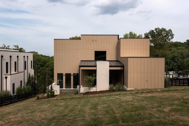 rear view of property featuring a yard