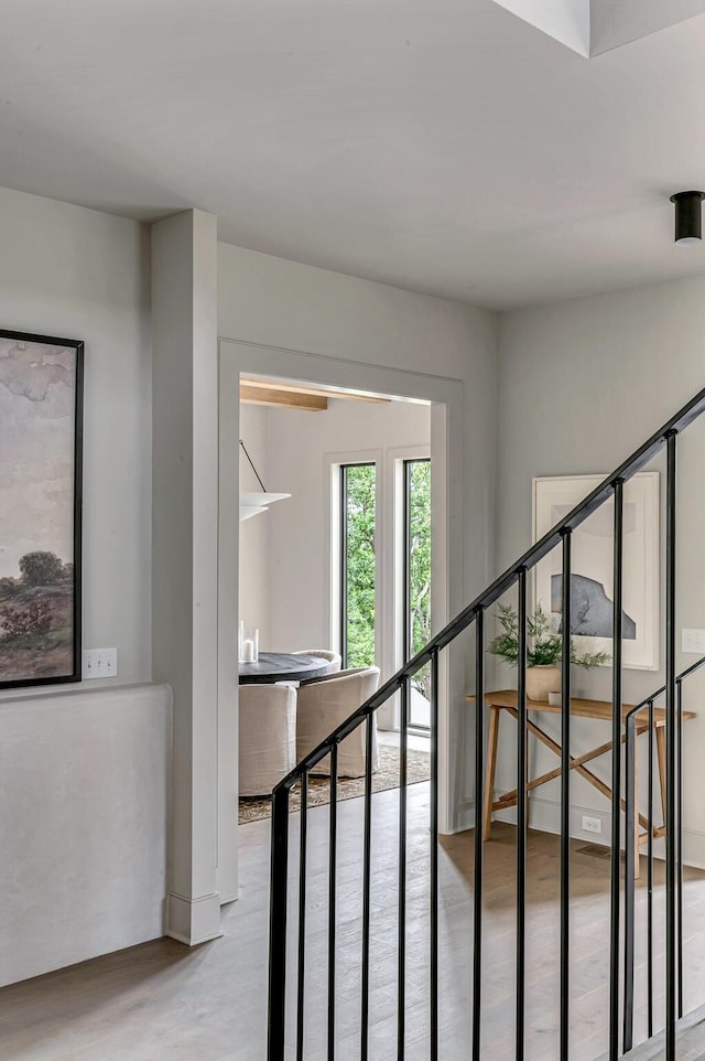 stairway with hardwood / wood-style floors