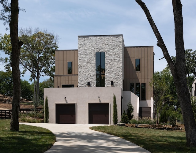 contemporary home featuring a front lawn and a garage