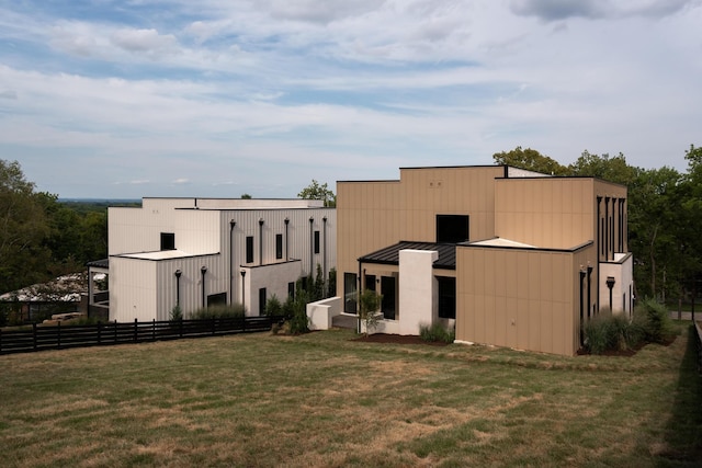 rear view of house featuring a lawn