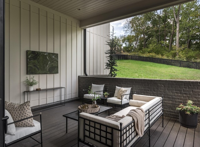 wooden terrace featuring a lawn and an outdoor living space