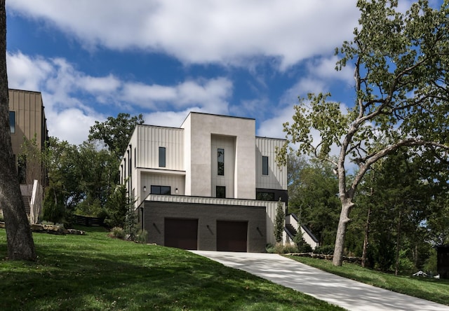 modern home featuring a garage and a front lawn