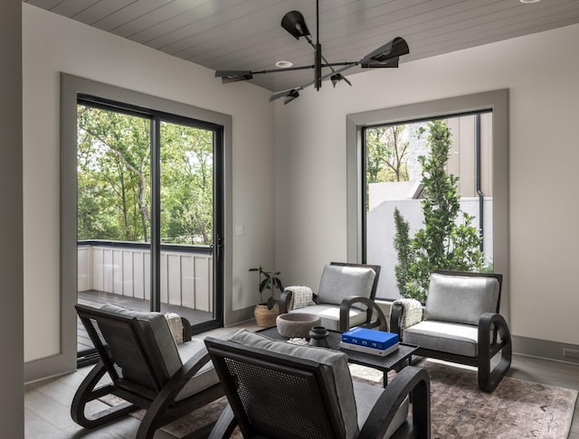 sitting room with wood ceiling and light hardwood / wood-style flooring