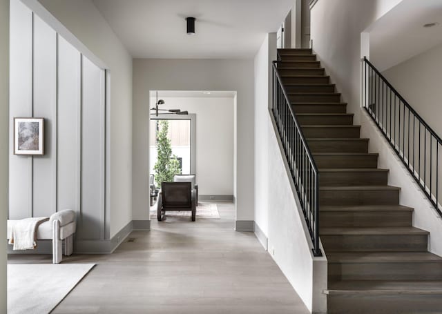 staircase with hardwood / wood-style floors