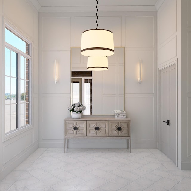 hallway with plenty of natural light and ornamental molding