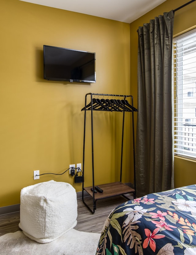 bedroom featuring hardwood / wood-style floors and multiple windows